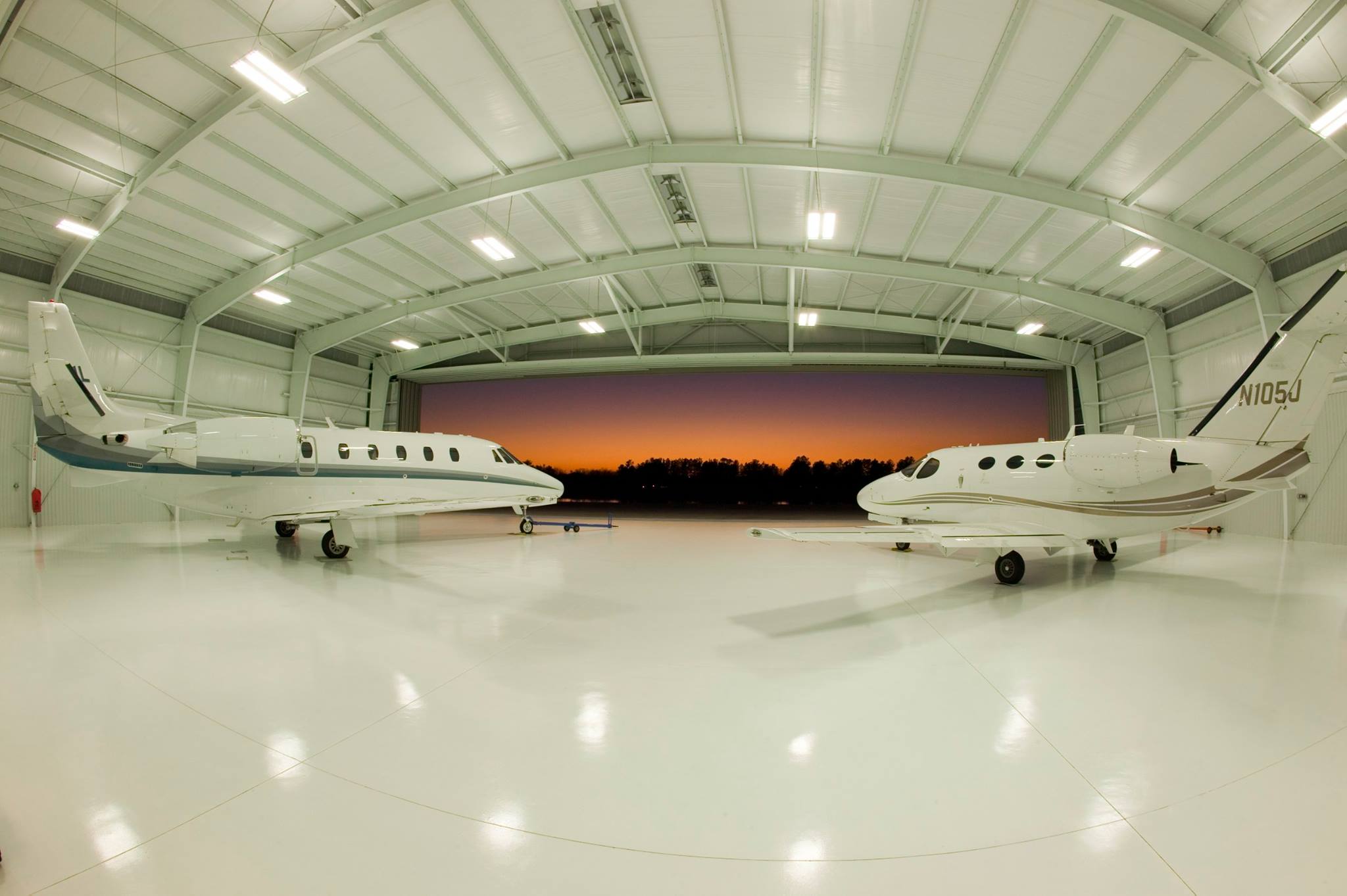 Steel Airplane Hangar Kits shown with two planes parked inside