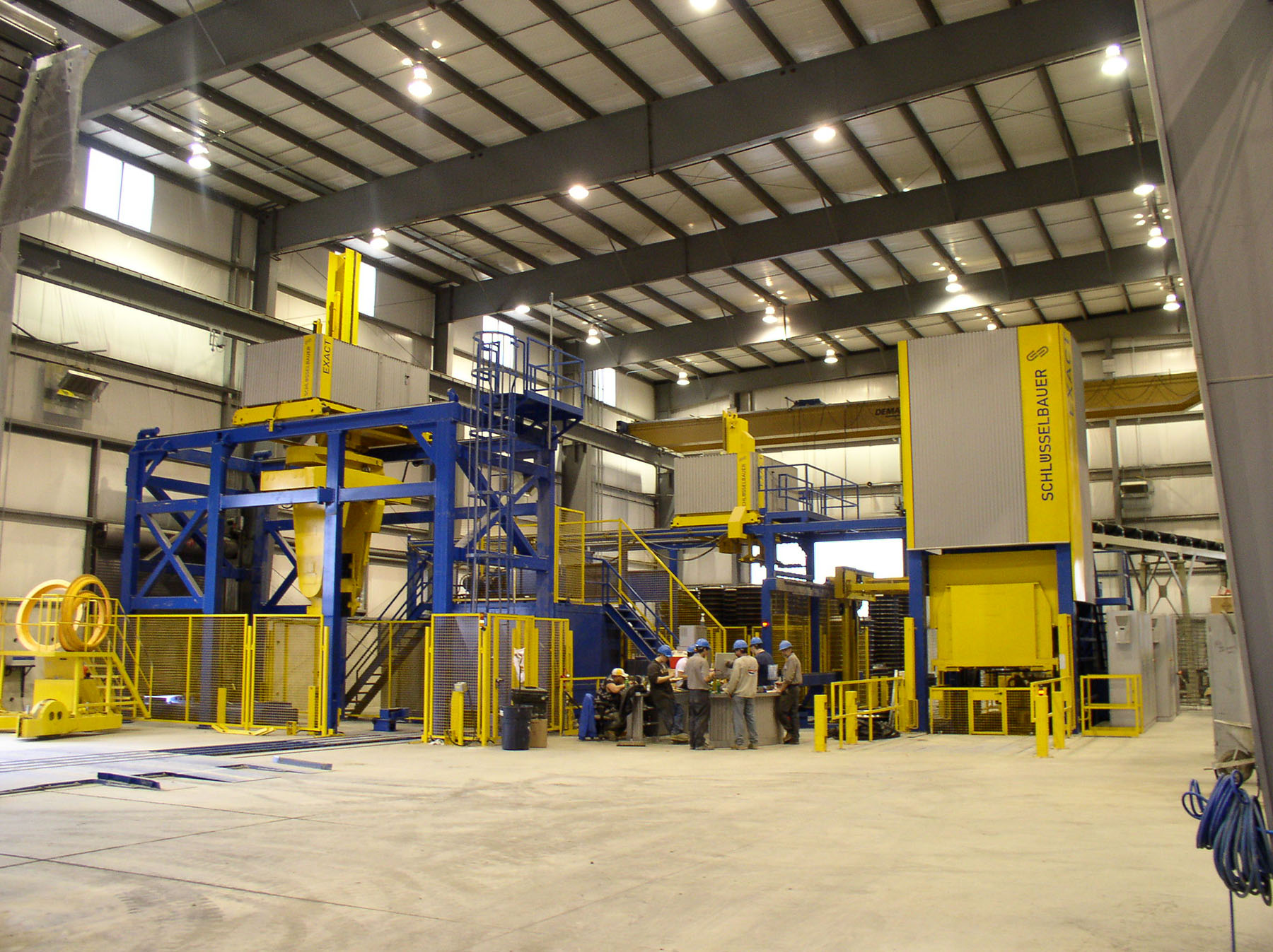 Workers inside a steel industrial building